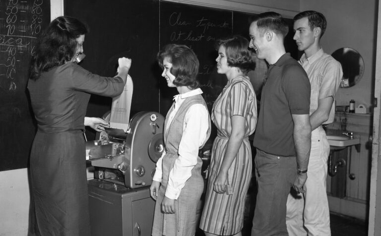 Students standing with an instructor.